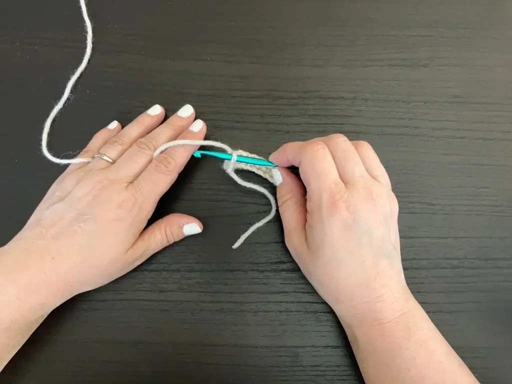 Hold a crochet hook with the knife grip technique.